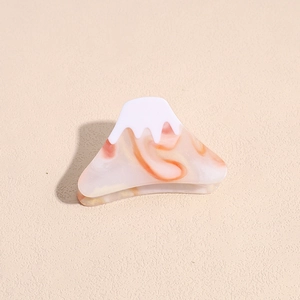 Detail of Mt. Fuji hair claw clip featuring a snow-white top and orange marble texture