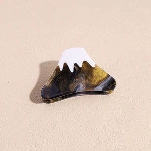 Detail of Mt Fuji acetate hair claw clip with snow-white top and marble texture