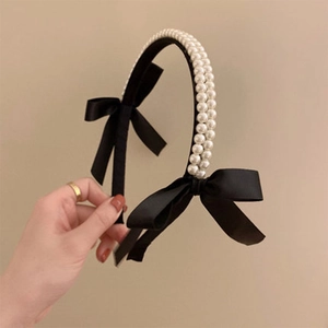 Elegant black bow headband with double-row pearls and satin ribbon in retro style