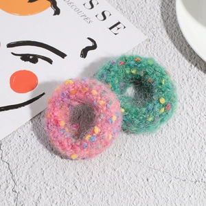 Pink and green plush polka dot hair scrunchies with soft colorful yarn texture