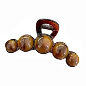Amber tortoiseshell hair claw clip with large pearl beads and elegant curved design