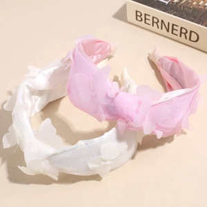 Sweet mesh headband with butterfly accents in white and pink on a minimal background