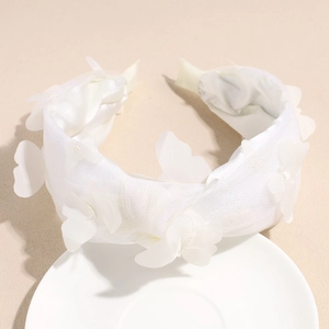 Detail of the white mesh butterfly headband with delicate handcrafted tulle petals