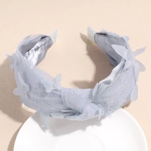 Close-up of light blue mesh headband featuring sparkling silver butterfly ornaments