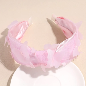 Detail of pink mesh headband with 3D fabric butterflies and soft satin lining