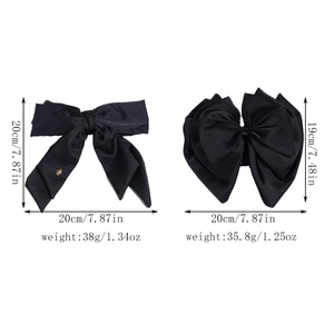 Elegant French black satin bow hair claws with gold logo detail on white background