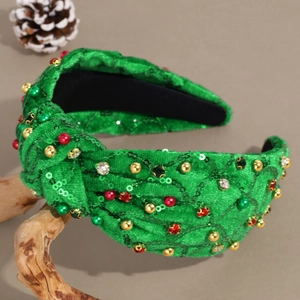 Détail du bandeau de Noël en velours vert avec strass et perles colorées élégantes