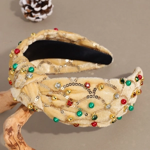 Détail du serre-tête de Noël en velours champagne avec strass colorés et paillettes dorées