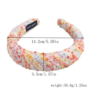 Detail of wide tweed headband showing colorful woven fabric and HAND MADE inner label