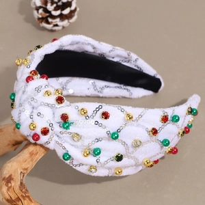 Détail du serre-tête de Noël en velours à nœud avec paillettes argentées et perles colorées