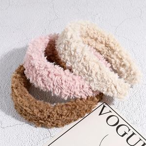 Three plush faux shearling wide headbands in pink, beige, and brown for winter