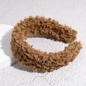 Detail view of brown teddy plush headband with textured lamb wool on a stone background