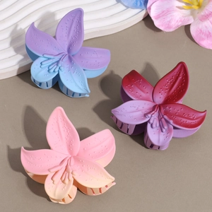 Three matte gradient flower hair claws in purple, red, and pink colors for elegant styling