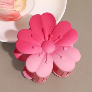 Detailed close-up of a matte gradient pink flower hair claw clip with floral petals