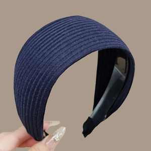 Detail of navy blue ribbed knit headband with inner toothed grip for non-slip styling