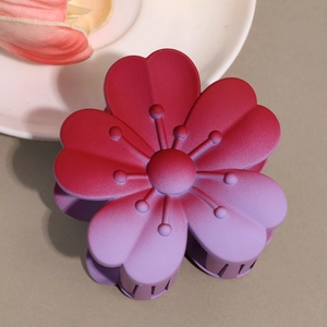 Detail shot of matte gradient plumeria hair claw clip with frosted pink petals