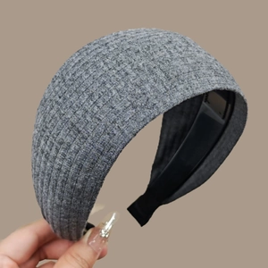 Detailed view of the gray knitted wide headband showing its ribbed texture and design