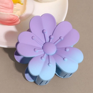 Close-up of matte purple and blue gradient flower hair claw clip with frosted texture