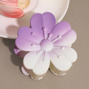 Close-up of matte purple and white gradient floral hair claw with detailed petals