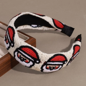 Dettaglio cerchietto in maglia bianca con ricami di Babbo Natale per le feste natalizie