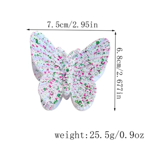 Detail showing dimensions of butterfly hair claw clip with colorful ink-splash patterns