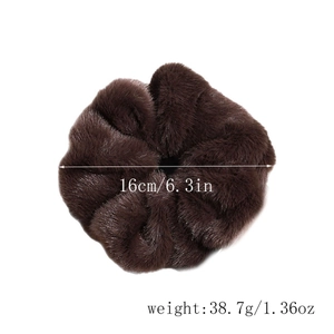 Detailed view of large plush hair scrunchie showing 16cm diameter and soft brown fur texture