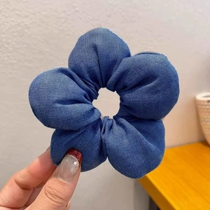 Detailansicht der blauen Denim-Stoffstruktur am floralen Haargummi Scrunchie