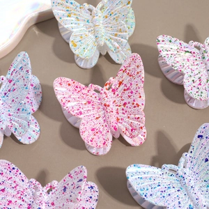 Elegant butterfly hair claw clips with colorful ink splash pattern on a pearly finish