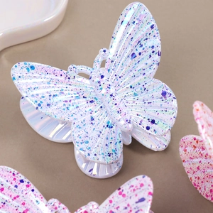 Iridescent butterfly hair claw clip with colorful ink splash pattern on white resin