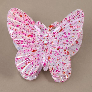 Detail of butterfly hair claw clip with vibrant pink ink splatter pattern on resin