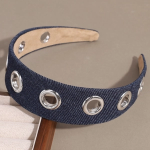 Top view of denim headband with silver metal eyelets and beige faux leather lining