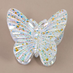 Detailed macro view of pearlescent butterfly hair claw with artistic ink splatters