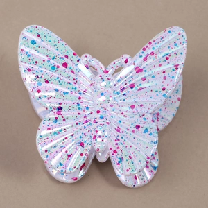 Detailed macro view of butterfly hair claw with colorful ink splash and pearlescent finish