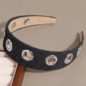 Detail of dark denim headband featuring silver metal grommets in a punk style