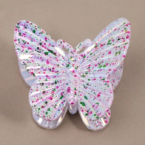 Close-up of pearl white butterfly hair claw clip with pink and green ink splatter detail