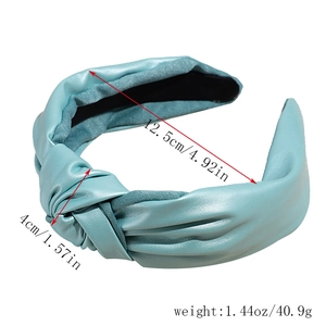 Detail showing light blue lychee pattern faux leather headband with size and weight labels