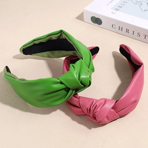 Minimalist wide-brimmed knotted leather headbands in bright green and soft pink