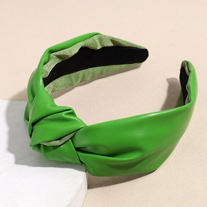 Detail of green PU leather knotted headband with textured surface and non-slip lining
