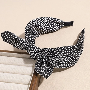 Detail of fabric knot headband with black and white floral pattern and non-slip ribbon tips