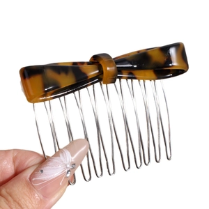 Elegant tortoise shell bow hair comb with ten silver metal teeth for stylish hair styling