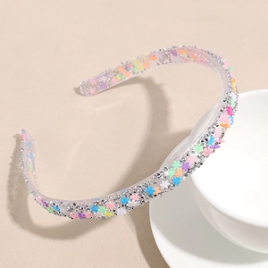 Close-up of a clear non-slip headband with colorful star sequins and silver glitter detail