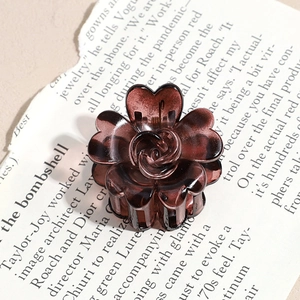 Detail shot of the translucent amber resin flower hair claw with rose carving pattern
