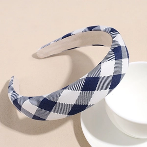 Macro detail of the thick blue and white checkered pattern fabric on a wide sponge headband