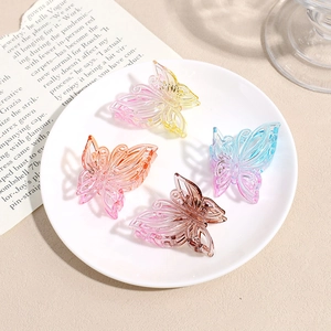 Lot de quatre pinces à cheveux papillon évidées aux dégradés transparents sur un plateau