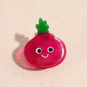 Vue détaillée d'une pince à cheveux mignonne en forme de betterave rose translucide