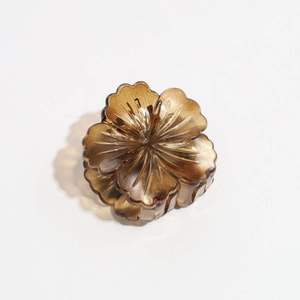 Detail view of amber resin flower hair claw clip with transparent petal texture