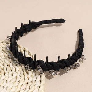 Detail view of black twisted fabric headband with sparkly crystal charms and anti-slip teeth
