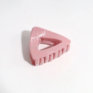 Pink triangular geometric hair claw clip with sparkling silver texture details