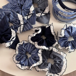 Navy blue plaid scrunchies and headband set with white ruffle edges and ribbon bows