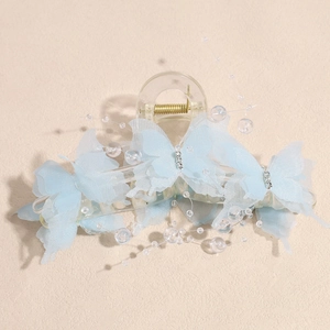 Detailed view of light blue butterfly hair claw clip with organza wings and bead accents